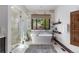Luxurious bathroom featuring a soaking tub and walk-in shower at 11164 Beatrice Ct, Littleton, CO 80125