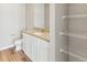 Bathroom with granite countertops, white cabinets, and wire shelving at 2164 Alyssa St, Fort Lupton, CO 80621