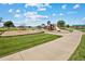 Community playground with swings, slides, and play structures at 2164 Alyssa St, Fort Lupton, CO 80621