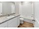 Bathroom with granite countertop, white cabinets, and bathtub at 2164 Alyssa St, Fort Lupton, CO 80621