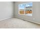 Bright bedroom with neutral carpet and a large window at 2164 Alyssa St, Fort Lupton, CO 80621