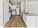 Modern kitchen with white cabinets, stainless steel appliances, and granite countertops at 2164 Alyssa St, Fort Lupton, CO 80621