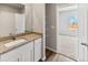 Bathroom with granite countertops, white cabinets and linen storage at 2164 Alyssa St, Fort Lupton, CO 80621