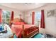 Cozy bedroom featuring a wooden bed frame and red bedding at 4545 Raritan St, Denver, CO 80211