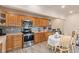 Modern kitchen with wood cabinets, stainless steel appliances, and a breakfast nook at 4545 Raritan St, Denver, CO 80211