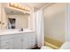 Clean bathroom with a shower/tub combo, vanity, and linen storage at 1709 Arapahoe Ave, Boulder, CO 80302