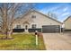 Two-story house with a gray garage door and well-maintained lawn at 6102 S Cody Way, Littleton, CO 80123