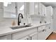 Modern kitchen sink and dishwasher in white cabinets at 6102 S Cody Way, Littleton, CO 80123