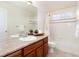 Clean bathroom with tub, shower, and wood cabinets at 10799 Eagle Crest Ct, Parker, CO 80138