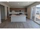 Modern kitchen with island, stainless steel appliances, and light wood cabinets at 8333 Vona Ln, Littleton, CO 80125