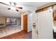 Kitchen features wood-look floors, white appliances, and a view into the living room at 350 S Clinton St # 7A, Denver, CO 80247