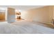 Living room with carpeted floors and an open view into the kitchen at 350 S Clinton St # 7A, Denver, CO 80247