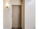 Apartment entry with neutral walls and flooring, a door, and an intercom at 350 S Clinton St # 7A, Denver, CO 80247