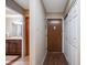 Apartment entryway with wood-look flooring, a door to the outside, and a door to a bathroom at 350 S Clinton St # 7A, Denver, CO 80247