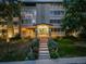 Night view of apartment building exterior with landscaping at 350 S Clinton St # 7A, Denver, CO 80247