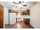 Kitchen with dark wood cabinets and white appliances at 350 S Clinton St # 7A, Denver, CO 80247