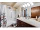 Bathroom with shower/tub combo, vanity, and floral shower curtain at 350 S Clinton St # 7A, Denver, CO 80247