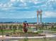 Community entrance roundabout with modern art sculpture and clock tower in the background at 24584 E 37Th Ave, Aurora, CO 80019