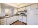 Galley kitchen with white appliances and granite countertops at 2604 S Xanadu Way # B, Aurora, CO 80014