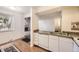 Simple kitchen with white cabinets, granite countertops, and a double sink at 2604 S Xanadu Way # B, Aurora, CO 80014