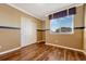 Bedroom with hardwood floors, neutral walls, and double door closet at 5772 S Addison Way # 30E, Aurora, CO 80016