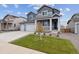 Two-story home with gray siding, three-car garage, and landscaped front yard at 5758 Ranch St, Mead, CO 80504