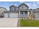 Two-story home with gray siding, three-car garage, and landscaped front yard at 5758 Ranch St, Mead, CO 80504