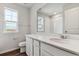 Clean and modern bathroom with white vanity, sink, toilet, and wood-look flooring at 5758 Ranch St, Mead, CO 80504