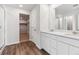 Spacious bathroom featuring double sinks, a walk-in shower and wood-like flooring at 5758 Ranch St, Mead, CO 80504