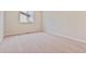 Empty bedroom with neutral-colored carpet and a large window at 5758 Ranch St, Mead, CO 80504