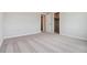 Empty bedroom with carpeted floors, closet, and adjacent bathroom access at 5758 Ranch St, Mead, CO 80504