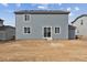 View of a two-story, gray home with a back patio and large backyard at 5758 Ranch St, Mead, CO 80504