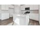 Bright, modern kitchen featuring white cabinets, stainless steel appliances, and a large island at 5758 Ranch St, Mead, CO 80504