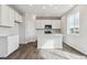 Bright kitchen featuring white cabinets, a center island, and stainless steel appliances at 5758 Ranch St, Mead, CO 80504