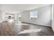 Living area with wood-look flooring, large windows, and access to the backyard at 5758 Ranch St, Mead, CO 80504