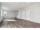 Living room with ample space, wood-look flooring, and multiple light fixtures at 5758 Ranch St, Mead, CO 80504