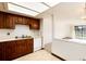 Kitchen boasts wood cabinets, white appliances, and views to the living room at 13961 E Marina Dr # 106, Aurora, CO 80014
