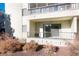 Private patio with sliding glass doors and landscaping at 13961 E Marina Dr # 106, Aurora, CO 80014