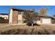 Brick house with attached garage and landscaping at 3875 E 123Rd Ave, Thornton, CO 80241