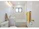 Updated bathroom with white vanity, marble tile, and gold fixtures at 701 S Lipan St, Denver, CO 80223