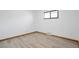 Simple bedroom with light walls and wood-look flooring at 701 S Lipan St, Denver, CO 80223