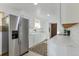 Bright kitchen with white cabinets, marble countertops, and stainless steel appliances at 701 S Lipan St, Denver, CO 80223