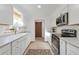 Renovated kitchen with white cabinets and stainless steel appliances at 701 S Lipan St, Denver, CO 80223