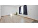 Light and airy living room with neutral walls and wood-look floors at 701 S Lipan St, Denver, CO 80223