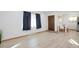 Spacious living room with wood-look floors and a view to the kitchen area at 701 S Lipan St, Denver, CO 80223