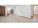 Open living area featuring light floors and access to kitchen and bathroom at 701 S Lipan St, Denver, CO 80223