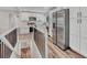 View of kitchen with stainless steel appliances and light wood flooring from a loft at 1490 S Ivy Way, Denver, CO 80224