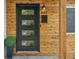 Modern front door with four glass panels and wood siding at 4643 S Cherokee St, Englewood, CO 80110
