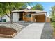 Modern craftsman style home with a carport and landscaped yard at 4643 S Cherokee St, Englewood, CO 80110