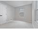 Spacious bedroom with neutral walls, carpeting, and a window at 4643 S Cherokee St, Englewood, CO 80110